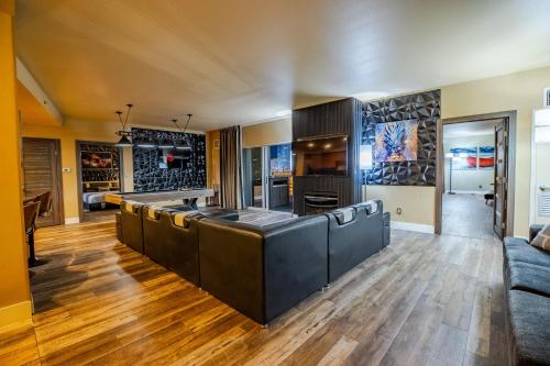 a large kitchen with a couch and a table at 2100 SqFt Penthouse Suite W/ Strip Views! POOL GYM in Las Vegas