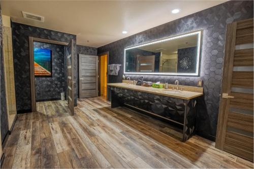 a bathroom with a large sink and a mirror at 2100 SqFt Penthouse Suite W/ Strip Views! POOL GYM in Las Vegas