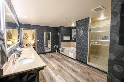 a bathroom with a sink and a shower and a tub at 2100 SqFt Penthouse Suite W/ Strip Views! POOL GYM in Las Vegas