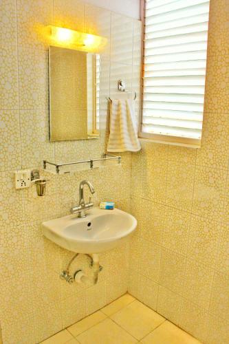 a bathroom with a sink and a mirror at Hotel Mystic Buddha in Kathmandu