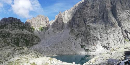 a mountain with a lake in front of it at Casa vacanze jsabel in Pieve Tesino