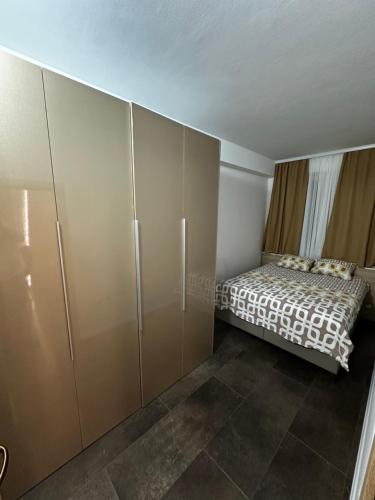 a bedroom with a bed and a large wardrobe at Cataleya in Sarajevo