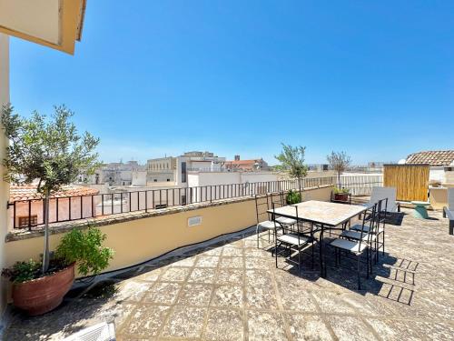 a patio with a table and chairs on a balcony at La Torretta - Marea Stays Collection in Otranto