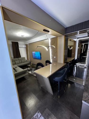 a room with a table and chairs and a couch at Cataleya in Sarajevo