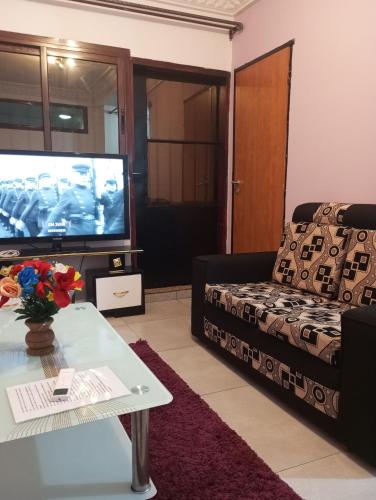a living room with a couch and a television at Golfe de Makepe in Douala
