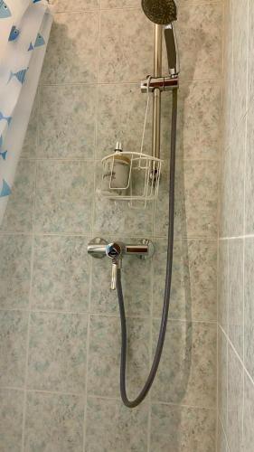 a shower with a hose in a bathroom at EJ Station Corner in Verona