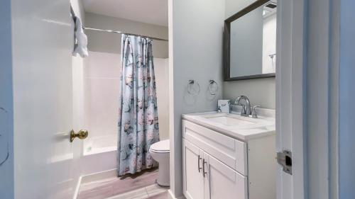 a bathroom with a sink and a toilet and a mirror at 825 Ketch Court at The Sea Pines Resort in Hilton Head Island