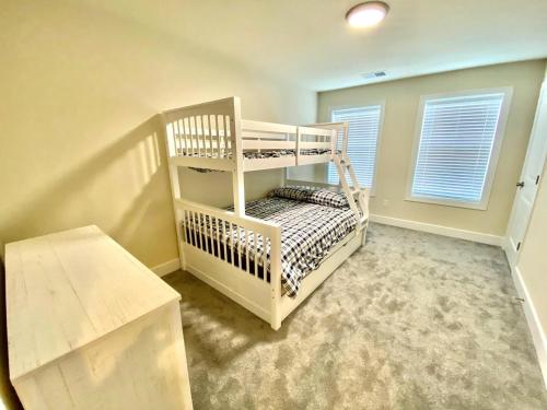 a bedroom with a white bunk bed in a room at Venice court 21675 in Dewey Beach