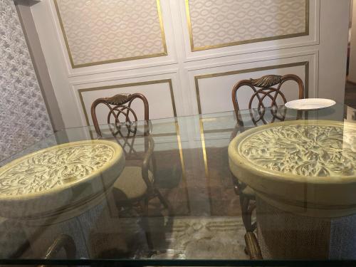 a glass table with two chairs on top of it at The Loraine Luxury Villa in Witbank