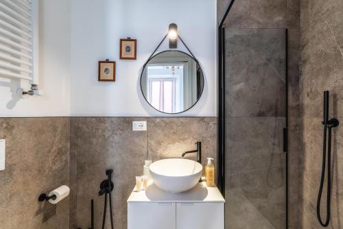 a bathroom with a sink and a mirror at Casa d'artista - Camere in residenza di Charme in Alassio