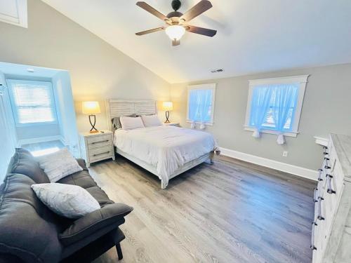Un dormitorio con una cama y un sofá y ventanas. en Central avenue 33476, en Frankford