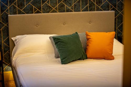 a bed with three pillows on top of it at Appartement de standing, Piscine, Tennis, Plage in Cannes