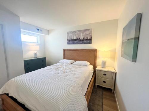 a small bedroom with a bed and a night stand at Olive avenue 1a in Rehoboth Beach