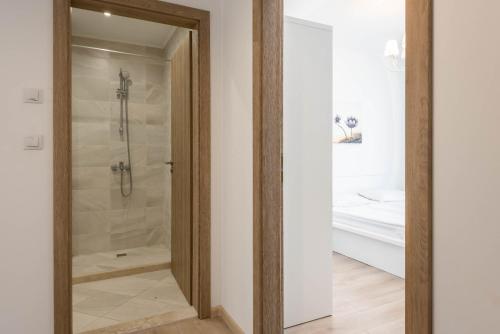 a bathroom with a shower with a glass door at Copacabacum Sea View in Varna City