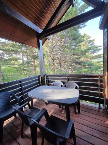 une table et des chaises sur une terrasse en bois dans l'établissement Le duplex de Dana, Gresse en Vercors, Alpes du Nord, classement 3 étoiles par Atout France, à Gresse-en-Vercors