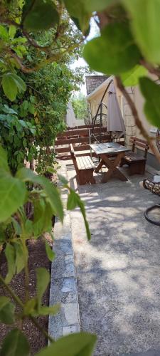 a patio with a picnic table and a tent at Apartments and Mobile Homes Makarska in Makarska