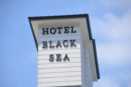a sign for a hotel with the words hotel black spa at Black Sea Hotel in Kvariati