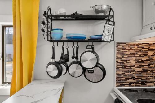 a kitchen with utensils hanging on a wall at Nothing Fancy Older Apt Walk to Downtown King Bed in Dover