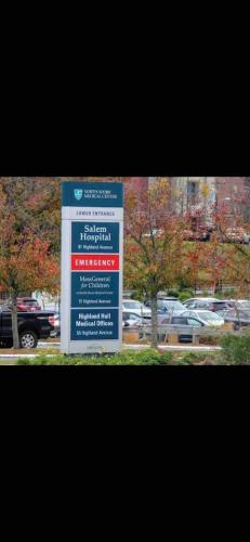a sign in front of a parking lot with cars at Charming Downtown Gem. 2 minutes to Salem. Workspace Included in Beverly