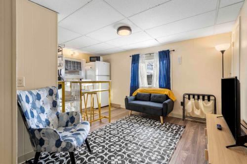 a living room with a couch and a kitchen at Charming and Tranquil Near Downtown and River parking Included in Dover