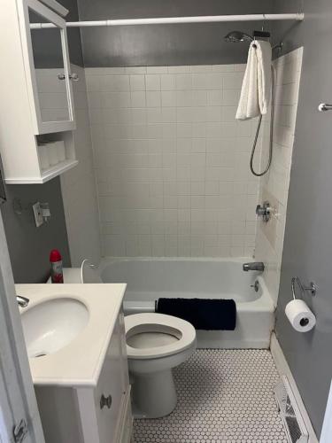 a bathroom with a white toilet and a sink at Beverly, Salem, Dwtn, Water and Train in Beverly