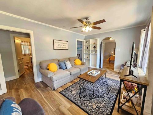 a living room with a couch and a ceiling fan at Serene Refurbished Gem Close to Coast and Downtown in Gulfport