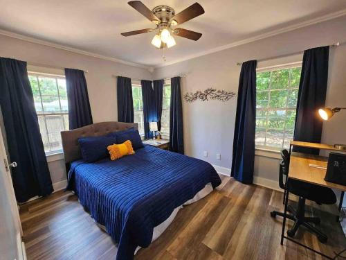 a bedroom with a bed and a ceiling fan at Serene Refurbished Gem Close to Coast and Downtown in Gulfport