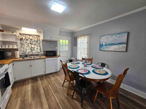 a kitchen and dining room with a table and chairs at Serene Refurbished Gem Close to Coast and Downtown in Gulfport