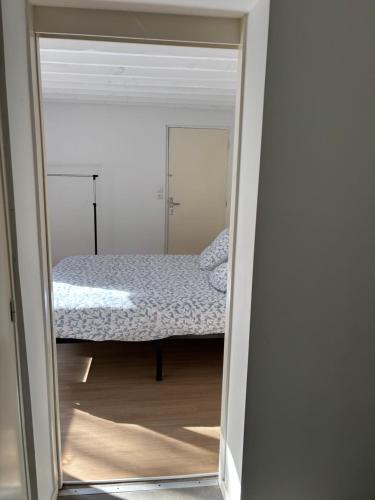 a bedroom with a bed through a mirror at G&J fourmidables in Récourt