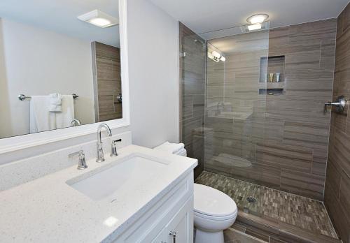 a bathroom with a sink and a toilet and a shower at 1255 Harbour Town Club at The Sea Pines Resort in Hilton Head Island
