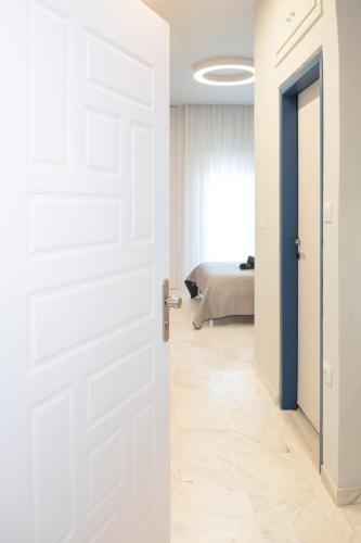 an open door leading to a bedroom with a bed at Blue Studio in Xanthi