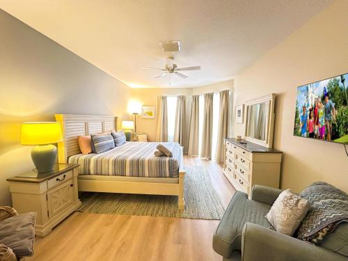 a bedroom with a bed and a couch at 5 bedrooms pool home Calabay in Davenport