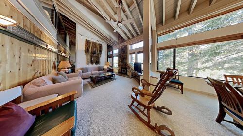 a living room filled with furniture and a large window at Comfortable 4 Bedroom Condo in Mammoth Lakes