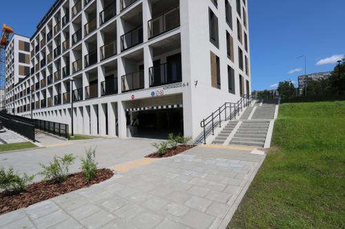 a large white building with stairs in front of it at Flat for 2 or 1 with Free Parking and Fast Wi-Fi in Vilnius