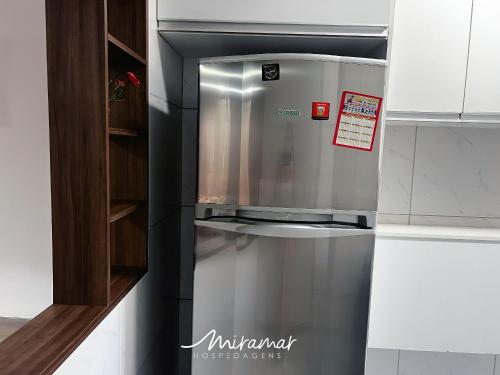 a stainless steel refrigerator sitting in a kitchen at Monte Mulanje-Miramar Hospedagens in Tambaú