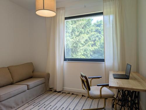 a living room with a couch and a window at Odpoczynek na wsi 