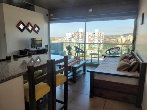 a living room with a view of a balcony at Los Naranjos in San Salvador de Jujuy