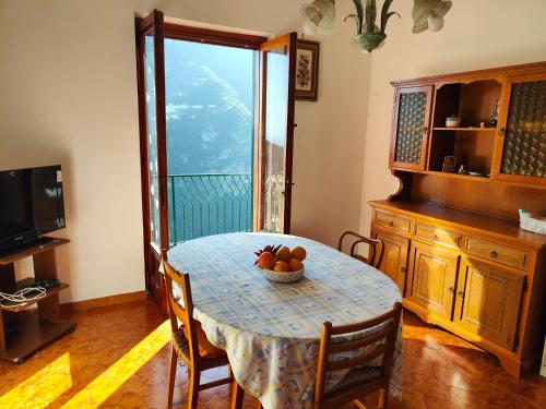 a dining room table with a bowl of fruit on it at Tra Cielo e Mare in Pontone