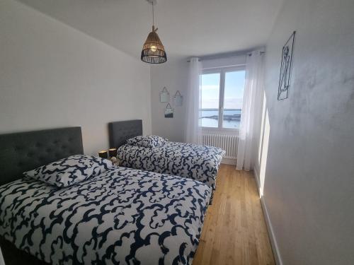 a bedroom with a bed and a window at House for 4 people with a breathtaking view in Plérin