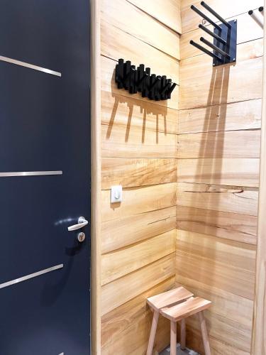 a door to a room with a wall of wine bottles at Chalet du Parc in Ax-les-Thermes
