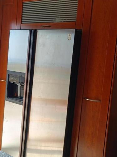 a glass door of a window in a wooden cabinet at Evgeniou House in Nea Triglia in Néa Tríglia