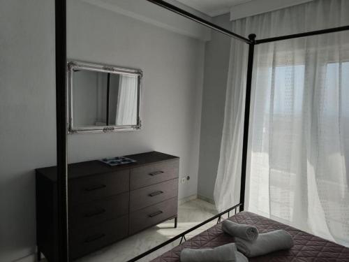 a bedroom with a dresser and a mirror at Evgeniou House in Nea Triglia in Néa Tríglia