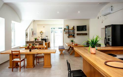 a living room with wooden tables and chairs at AZOGIRE Resort in Azoyirés