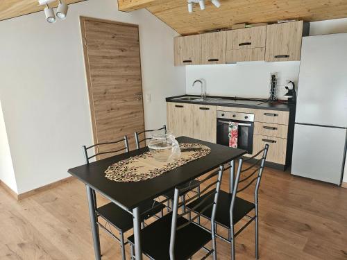 a kitchen with a table and chairs in a room at Attico Essebi in Bellinzona