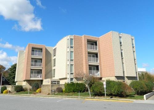 a largeartment building on the side of a street at The crest 403 in Rehoboth Beach