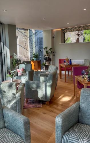 a living room with couches and chairs and a table at Pen-Y-Dyffryn Country Hotel in Oswestry