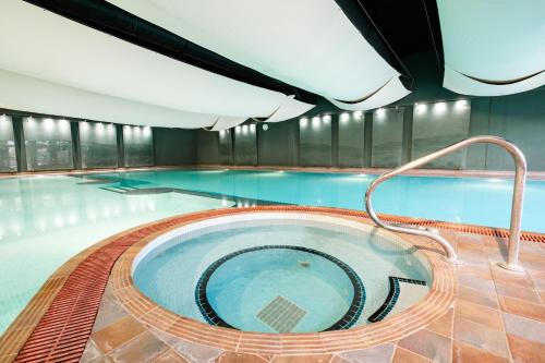 a swimming pool with a hot tub in a building at Lakeside Hotel and Spa in Newby Bridge
