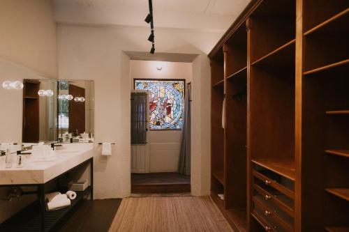 a bathroom with a sink and a stained glass window at Casa Seis Siete in Mexico City