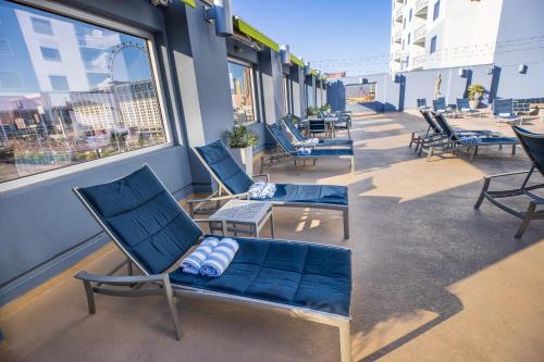a balcony with chairs and a couch on a building at 2100 SqFt Penthouse Suite W/ Strip Views! POOL GYM in Las Vegas
