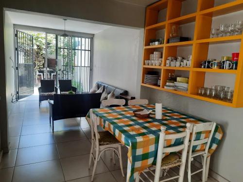 a dining room with a table and some chairs at Spectacular House in Barrio Sur with a pool in San Miguel de Tucumán